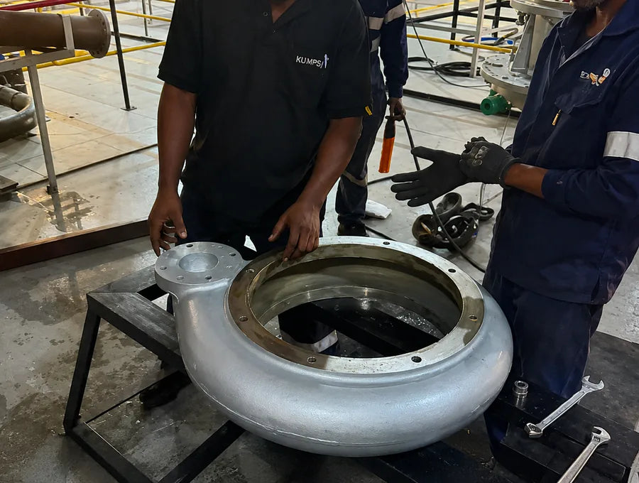 Technicians assessing a pump casing in the workshop